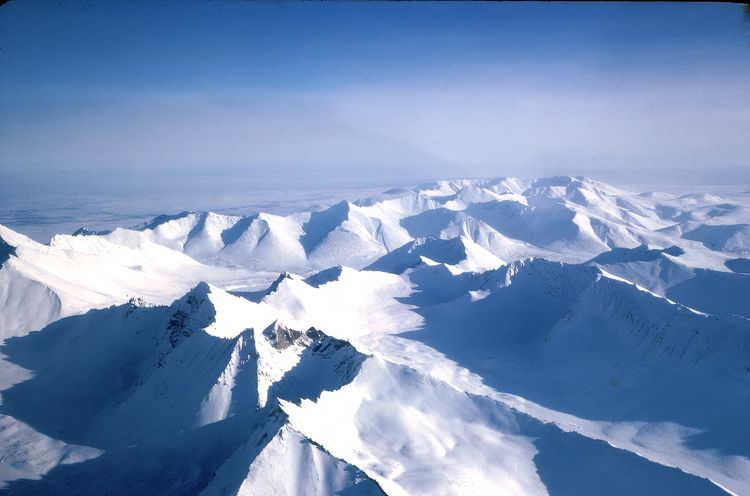 Kigluaik Mountain Range (Sawtooth Mountains), just about 34 miles north of Nome. Having left Nome about 20 minutes ago, you'd be one-fourth of the way to Shishmaref, maybe 45-50 minutes away. Today, with faster planes, travel from Nome to Shishmaref takes about a half hour.