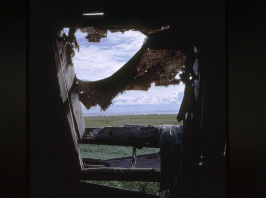 View from inside the sod house. Note the summer tents pitched on the shore of the inlet.  John Hallum, who lived in this sod house for several years, showed nearly everyone who was willing how to play chess. He held chess tournaments  and said they learned to play very well. Unk Rod (Roderick Seetomona) was one of the champs.