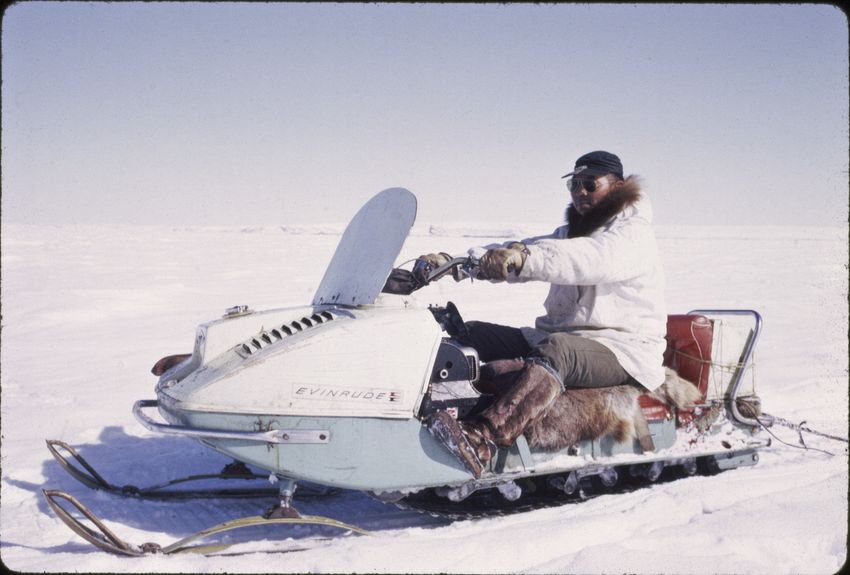 (21, 22) Andrew Ningeulook with one of Shishmaref's first snowmachines, referred to as Ski-Doos. He later had a fatal heart attack while hunting around Ear Mountain.