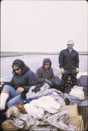 Captain Russell Nayokpuk, operating the outboard, with Delbert Obruk (sitting, next to Russell). Picture is most likely in the one of the forks at Serpentine River system. (Note the ever present "Sailor Boy cracker", nicknamed "the Eskimo cookie.")